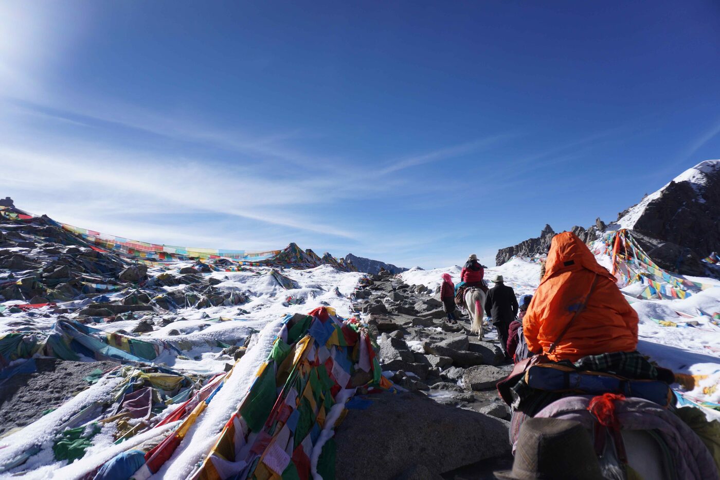 Prayer flags and snow at Dolma La. The Ponies kept slipping on the hard snow.